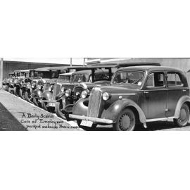 "A Daily Scene, Cars of Employees Parked Outside Premises"